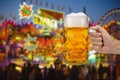 Glass of beer holding in hand at Oktoberfest in Munich Royalty Free Stock Photo