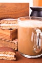 Big mug of hot cocoa with foam and chocolate biscuit halves Royalty Free Stock Photo