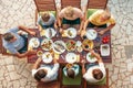 Big multigenerational family dinner in process. Table with food and hands. Food consumption and multigenerational family Top view