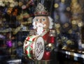 Big nutcracker toy drummer among blurred Christmas lights Royalty Free Stock Photo