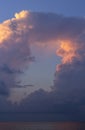 Big O-shaped cloud over the sea water. Evening sky. Cloud in the form of a portal Royalty Free Stock Photo