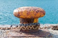 big oarange old rusty mooring bitt on a dock Royalty Free Stock Photo