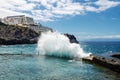 Big ocean wave breaking on natural swimming pool in town Los Gigantes `Cliffs of the Giants`. Canary Islands, Tenerife, Spain.