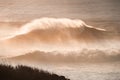 Big ocean wave crashing near the coast at sunset Royalty Free Stock Photo