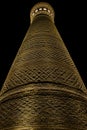 Big old ancient minaret in lights at night Royalty Free Stock Photo