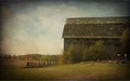 Old barn, fence and field. Copy space. Vintage look with texture and vignetting.