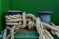 A big old cleat with classic mooring rope tied on it Royalty Free Stock Photo