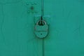 Big old iron green lock hanging on a metal door Royalty Free Stock Photo