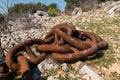 Big old rusty anchor chain lying on the ground Royalty Free Stock Photo