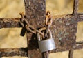 Big old rusty padlock with the chain and the closed gate Royalty Free Stock Photo