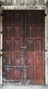 Big old wooden door with peeling varnish