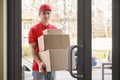 Big online shopping and home delivery. Courier holds many cardboard boxes