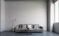 Big open industrial hangar with concrete walls, floor and ceiling. Template with sofa, table, lamp and space above for text