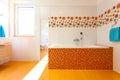 Big orange bath in cute contemporary bathroom Royalty Free Stock Photo