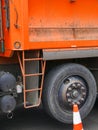 Big orange dump truck detail with tire