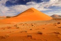 Big orange dune with blue sky and clouds, Sossusvlei, Namib desert, Namibia, Southern Africa. Red sand, biggest dune in the world Royalty Free Stock Photo
