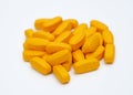 Big orange pills on a white background. Royalty Free Stock Photo