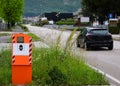 Big orange Safety Speed Camera and a black car on the road