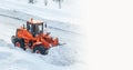 Big orange tractor removes snow from the road and clears the sidewalk Royalty Free Stock Photo