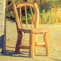 Big orange wooden chair in a garden Royalty Free Stock Photo