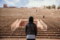 Symmetrical Portrait of Male Person Standing Front and Center on a Stage Dreaming and Imagining the Future while Facing Stadium St