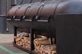 Big outdoor commercial grill with firewood at summer local food festival