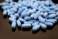 Big oval blue tablets closeup with sofl natural shadows and reflection on black background Royalty Free Stock Photo