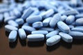 Big oval blue tablets closeup with sofl natural shadows and reflection on black background Royalty Free Stock Photo