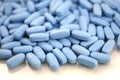 Big oval blue tablets closeup with sofl natural shadows and reflection on white background Royalty Free Stock Photo