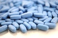 Big oval blue tablets closeup with sofl natural shadows and reflection on white background Royalty Free Stock Photo