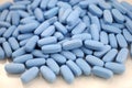 Big oval blue tablets closeup with sofl natural shadows and reflection on white background Royalty Free Stock Photo