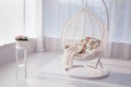 Big oval white artistic chair in a white room