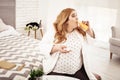 Big overweight young woman drinking freshly-made orange juice Royalty Free Stock Photo