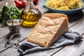 Big parmesan cheese slice on a table full of ingredients for Italian cuisine Royalty Free Stock Photo