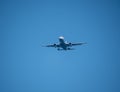 Big passenger airplane flying in blue sky