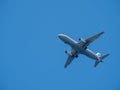 Big passenger airplane flying in blue sky