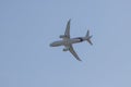 Big passenger white plane flying in the blue sky - bottom view Royalty Free Stock Photo