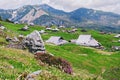 Big Pasture Plateau in the Kamnik Alps, Slovenia. Mountain cottage hut or house on green hill. Alpine meadow landscape. Farm