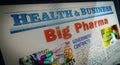 Big Pharma and pharmaceutical business newspaper on mobile tablet screen