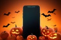 Big phone mock up blank screen on Happy Halloween pumpkins background.