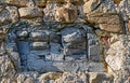 Big piece of a cracked slate in an old stone wall