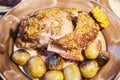 The big piece of the grilled stewed pork with mustard sauce lies on a plate with potatoes and corn, Juicy meat Royalty Free Stock Photo