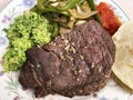 Big Piece of Sirloin Steak with Red Salsa, Tortilla, Onions, Green Pepper and Guacamole