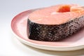 A piece of raw atlantic salmon steak on a plate Royalty Free Stock Photo