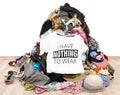 Big pile of clothes thrown on the ground with a t-shirt saying nothing to wear. Royalty Free Stock Photo