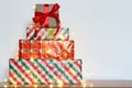 Big pile of colorful wrapped gift boxes isolated on wood table and white background. Mountain gifts. Royalty Free Stock Photo