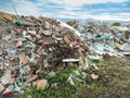 Big pile of construction waste near the town, conceptual image of human negligence.