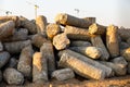 Close up of big pile of cut concrete piles at construction site, tower cranes on background Royalty Free Stock Photo