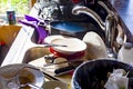 A big pile of dirty dishes, pots, utensils stacked into kitchen sink. Royalty Free Stock Photo