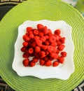 Big pile of fresh raspberries in white bowl isolated on light green background Royalty Free Stock Photo
